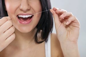 Woman Flossing teeth
